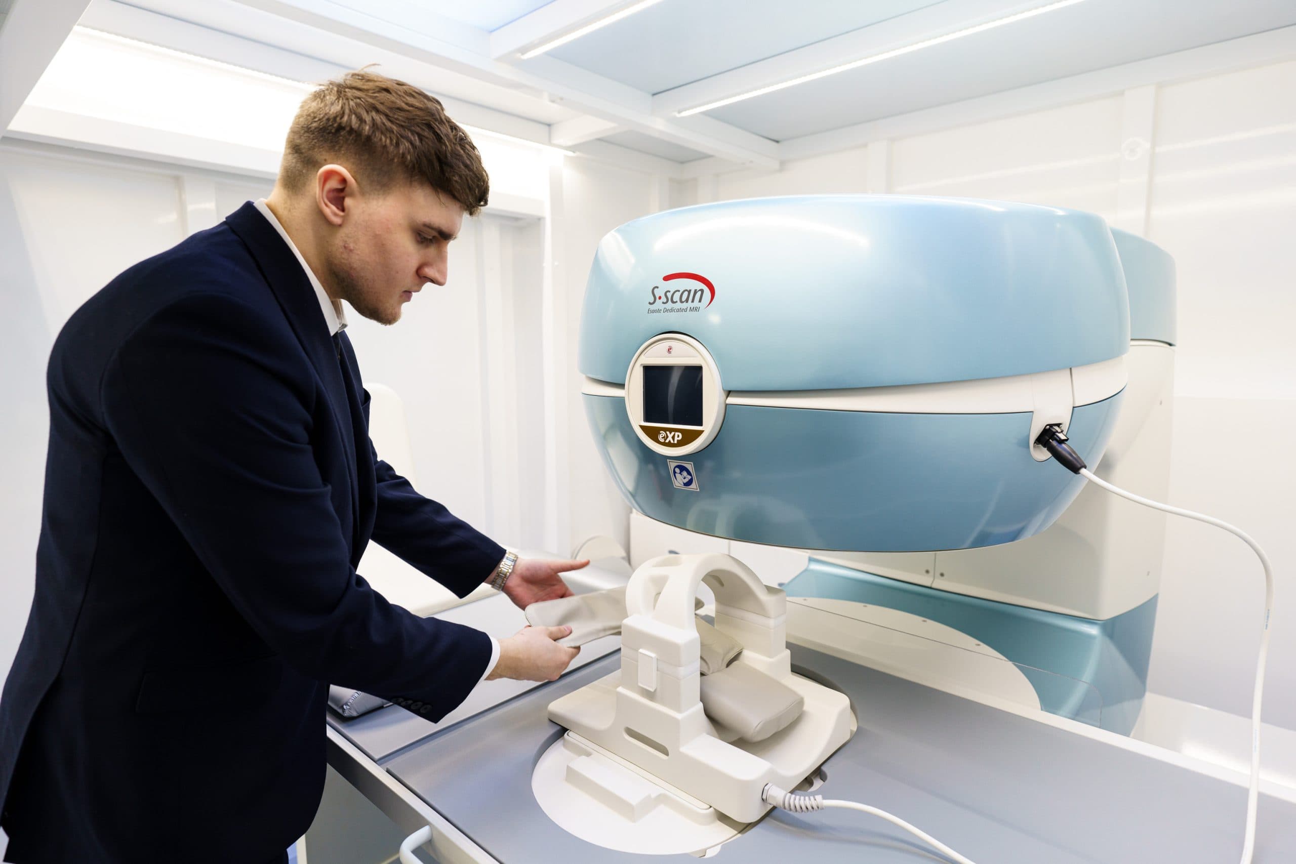 Clinician preparing knee scanner equipment